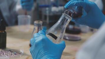 a scientist is working in a laboratory, a chemical researcher is preparing sample for a vaccine against a virus, work in lab concentrate is the most important because chemicals are dangerous video