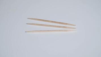Three toothpicks rotate on a gray background video