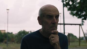 Pensive Elderly Man Sitting In Natural Park Reflecting On The Past video