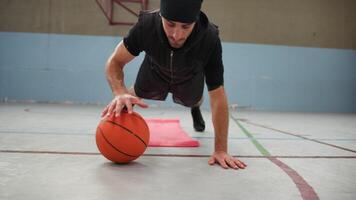Push Up Exercise Alternating With Basketball Ball On The Ground video
