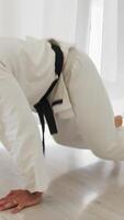 Man In White Karate Uniform Does Abs Exercises video