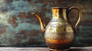 A beautifully crafted antique brass teapot features detailed engravings and a polished finish. It is placed on an aged wooden table, complementing the rustic, textured background. video