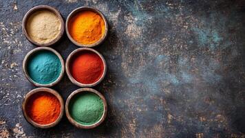 A collection of colorful spices displayed in round wooden bowls sits atop a weathered, textured surface. Each bowl features a unique spice, creating an inviting visual experience. video