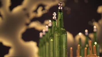 Green glass bottles with silver caps and numbered wooden tags on a table, with a blurred map background video