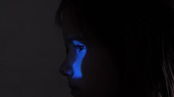 Light through keyhole falls on child's face. child looking through keyhole peeping through door.close up curious little girl peeping through keyhole in door. Peeping, curiosity video