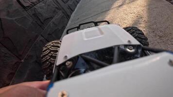 POV Remote control car navigating concrete pathways and grassy terrain showcases dynamic movement and captures the essence of outdoor adventure and exploration video