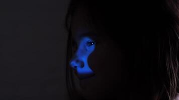 smiling girl little girl. Light through keyhole falls on child's face. child looking through keyhole peeping through door.close up curious little girl peeping through keyhole in door. video