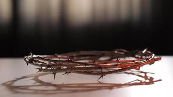 Crown of thorns is casting a shadow on a white surface. Light is coming from the back, creating a gradient from light to dark video