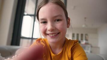 Mobile phone point of view happy Caucasian child glad schoolgirl at home touch display device little girl typing screen smiling kid daughter chatting online app playing virtual game addict POV webcam video