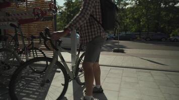 Man parks his bicycle in two-level bicycle parking lot in Munich, Germany. Double decker bicycle parking lot. Bicyclist parking his cycle in a split level bicycle parking lot. Cycling infrastructure video