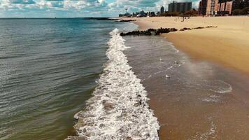 Aerial view of shoreline with crashing waves, sandy coast at Coney Island Beach in Brooklyn video