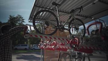 Man parks his bicycle in two-level bicycle parking lot in Munich, Germany. Double decker bicycle parking lot. Bicyclist parking his cycle in a split level bicycle parking lot. Cycling infrastructure video