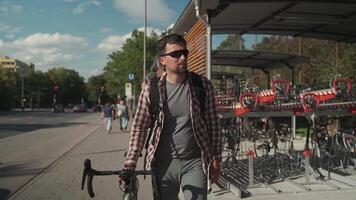Man parks his bicycle in two-level bicycle parking lot in Munich, Germany. Double decker bicycle parking lot. Bicyclist parking his cycle in a split level bicycle parking lot. Cycling infrastructure video