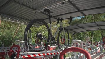 Cycle stored in two levels of modern parking on second floor. Bicycle infrastructure. Modern split-level bike rack storage. Dual tier cycling stand. Bicycle hub. Duplex velocipede parking. video