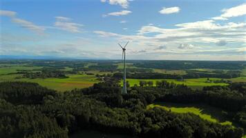 Aerial view of wind turbine in Bavaria, Ebersberg region, Germany. Luftaufnahme einer Windturbine vor dem Hintergrund der Alpen in Bayern, Deutschland. Wind turbine on golf course overlooking alps. video