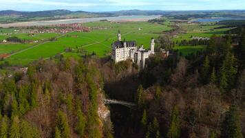 Aerial view Neuschwanstein Castle and bridge Marienbrucke across Pollat gorge in Ammergau Alps. View of famous Neuschwanstein Castle, Fussen, Bavaria, Germany and Marys bridge over cliff video