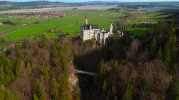 Aerial view Neuschwanstein Castle and bridge Marienbrucke across Pollat gorge in Ammergau Alps. View of famous Neuschwanstein Castle, Fussen, Bavaria, Germany and Marys bridge over cliff video