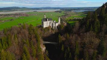 Aerial view Neuschwanstein Castle and bridge Marienbrucke across Pollat gorge in Ammergau Alps. View of famous Neuschwanstein Castle, Fussen, Bavaria, Germany and Marys bridge over cliff video
