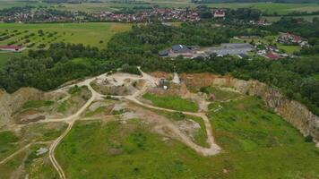 Aerial view of an abandoned mining quarry in Germany im Landkreis Dillingen. Open pit mines drone view. Steinbruch Luftaufnahme in Deutschland, Bayern in der Stadt Haunsheim. Mining equipment. video