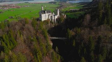 Aerial view Neuschwanstein Castle and bridge Marienbrucke across Pollat gorge in Ammergau Alps. View of famous Neuschwanstein Castle, Fussen, Bavaria, Germany and Marys bridge over cliff video