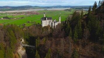 Aerial view Neuschwanstein Castle and bridge Marienbrucke across Pollat gorge in Ammergau Alps. View of famous Neuschwanstein Castle, Fussen, Bavaria, Germany and Marys bridge over cliff video