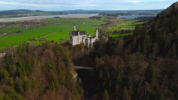 Aerial view Neuschwanstein Castle and bridge Marienbrucke across Pollat gorge in Ammergau Alps. View of famous Neuschwanstein Castle, Fussen, Bavaria, Germany and Marys bridge over cliff video
