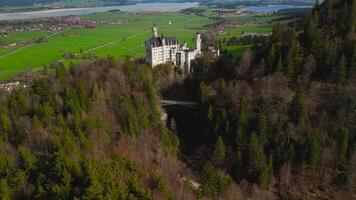Aerial view Neuschwanstein Castle and bridge Marienbrucke across Pollat gorge in Ammergau Alps. View of famous Neuschwanstein Castle, Fussen, Bavaria, Germany and Marys bridge over cliff video