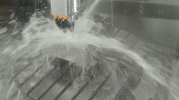 Demonstrate of CNC milling machine cutting the steel parts with water coolant method. video