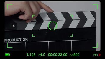 Close up hand holding empty film slate and clapping in front of camera. video