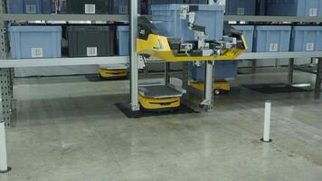 Demonstration of Smart warehouse management system with robotic handling system. Automated robotic tote arranging distribution product stock on shelf in modern factory. AI Technology Logistic concept. video