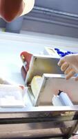 Hands are forming dough for pizza on floured table and kneading it. Chef is shaping floured dough for pizza. Process of preparing pizza. Close up. Vertical video