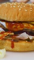 Amazing tasty appetizing burger with various fresh ingredients and buns. Fast food concept. Close up. Vertical video