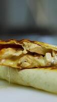 Tasty pita roll with vegetables and meat poured with red souce. Tasty fast food prepared in restaurant. Vertical video