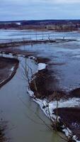 Ecology in danger. Dirty lake with polluted water in the countryside. Ecological disaster. Environmental problems. Aerial view. Vertical video