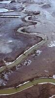 Natural problems of water. Dirty stream of dried lake. Gloomy background of environment. Global warming. Aerial view. Vertical video