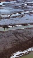 Muddy river. Dirty environment. Tortuous river in drought place. Polluted nature background. Aerial view. Vertical video