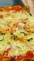 Cook decorates ready pizza. Chef's hand in glove is sprinking fresh green sprouts on a baked pizza in a restaurant. Close-up. Vertical video