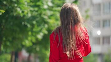 Woman talking on phone. Young charming woman calling with cell phone while walking in park video
