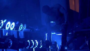 Working out with dumbbells. Lifestyle portrait of handsome muscular man with dumbbell video
