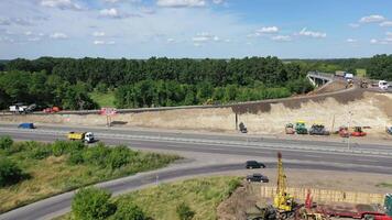 Asphalt road under construction. Aerial view aboveroad construction worker, view from drone video