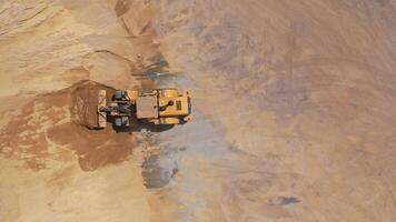 Road under construction. Top view of heavy machine working in construction site video