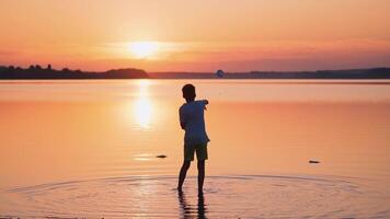 Child playing paper airplane. Joyful caucasian funny boy plays and enjoys in the river video