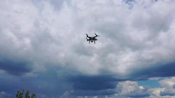 Flying drone over fields. Drone capturing aerial shots using camera against a blue sky video
