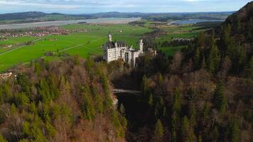 Aerial view Neuschwanstein Castle and bridge Marienbrucke across Pollat gorge in Ammergau Alps. View of famous Neuschwanstein Castle, Fussen, Bavaria, Germany and Marys bridge over cliff video
