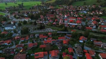 Drone view of sunset train ride in Alps in summer. Aerial view of railroad train traveling in Germany, Bavaria. Top view of train going in Schliersee in Bayern, Deutschland. Railway transportation. video
