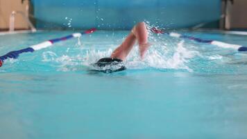 Swimmer splashing in pool lane, Swimmer creating splashes while practicing in a pool lane video