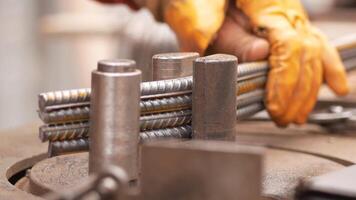 A skilled craftsman meticulously shaping metal using a clamp, set in a dynamic workshop environment video