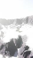 row of sharp dark cliffs standing out from the snow video