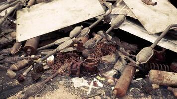 A chaotic pile of discarded metal scraps and tools in an abandoned workshop video