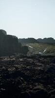 A rocky area with a small stream running through it video